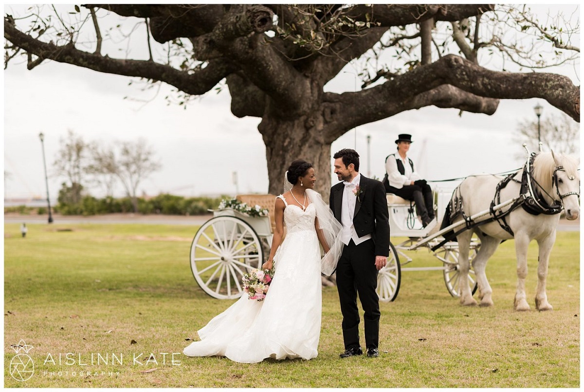 A photo of a horse and carriage and a bride in groom at the Barkley House. 