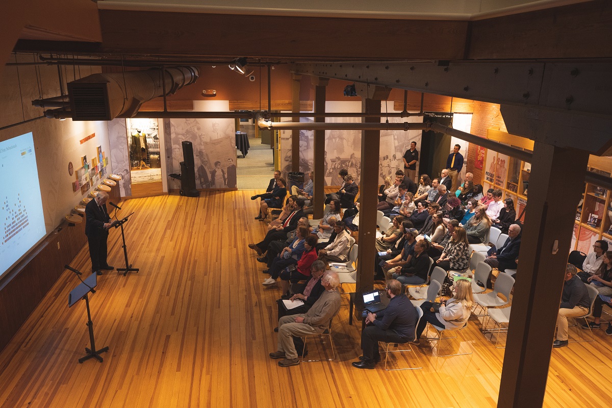 People at a lecture in the gallery room at Voices of Pensacola.